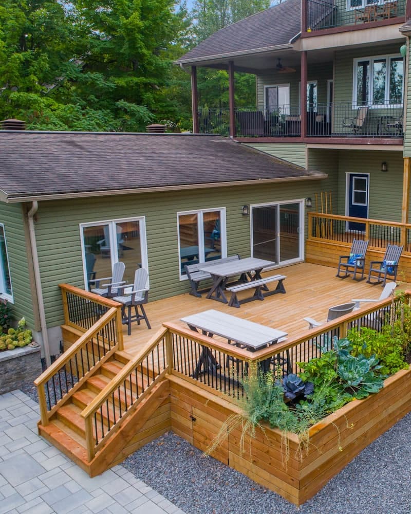A multi-level wooden deck attached to the back of a home
