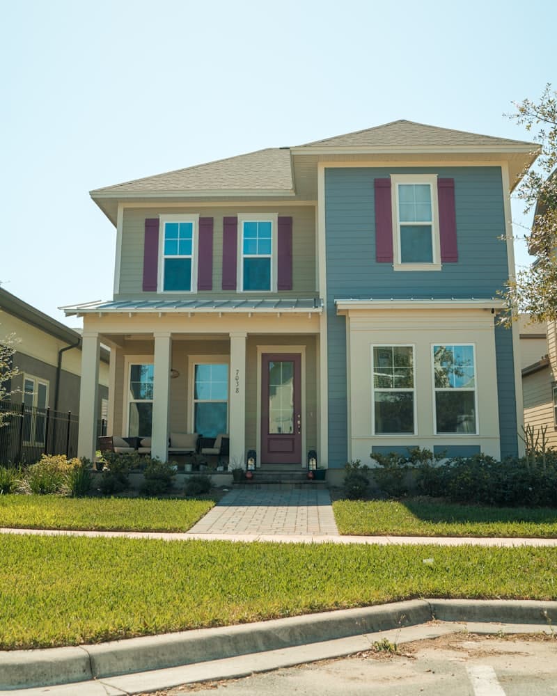 A two-tone painted house exterior in blue and cream