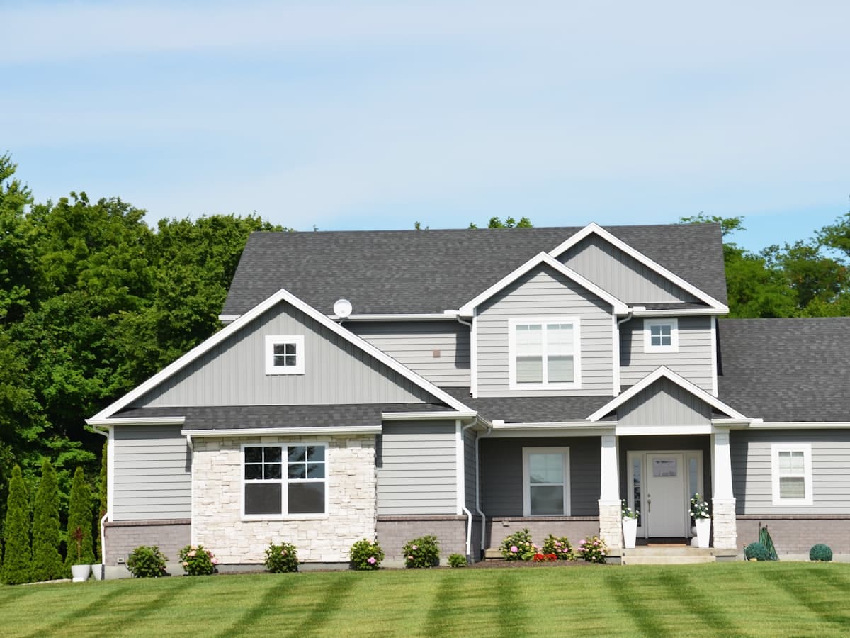 A two-story suburban home with a manicured lawn in a planned community